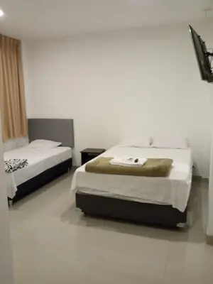 a bedroom with two beds in a room at Keylas Hotel in Ica