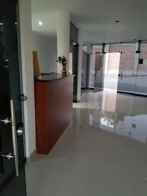 an empty hallway with a desk in a building at Keylas Hotel in Ica