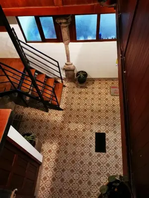an overhead view of a room with a staircase and a tile floor at Casa Durand in Cusco