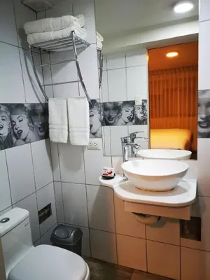 a bathroom with two sinks and a toilet and a mirror at Casa Durand in Cusco