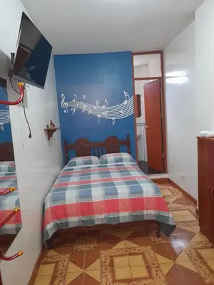 a bedroom with a bed with music notes on the wall at Nasca Trails B&B in Nazca