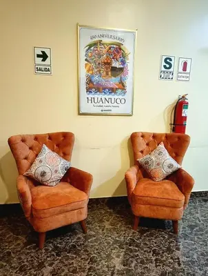 two chairs sitting next to each other in a room at Lembranças Hotel in Huánuco