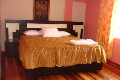 a bedroom with a bed with two pillows on it at Qolqampata Hotel in Cusco