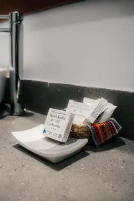 a basket of books on a plate on a counter at Hotel Andes Urubamba in Urubamba