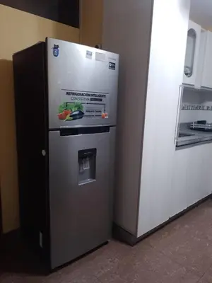 a refrigerator is next to a white refrigerator freezer at Runawasi Caribe, Lima centric 2BDR, 20 min from airport in Lima