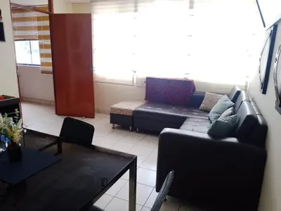 a living room with a couch and a table at Runawasi Caribe, Lima centric 2BDR, 20 min from airport in Lima