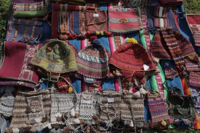 a pile of knitted hats on a blanket at Hotel Casa Campesina in Cusco