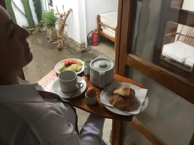 a person sitting at a table with a plate of food at Posada Junco y Capuli in Huancayo