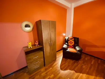 a room with a cabinet and a chair and a mirror at BROTHERs HOUSE in Cusco