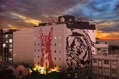 a tall white building with a mural on the side of it at Radisson RED Miraflores in Lima