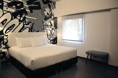 a bedroom with a bed and a painting on the wall at Radisson RED Miraflores in Lima