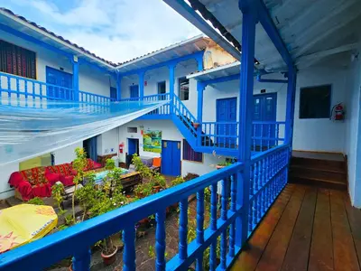 a balcony of a house with blue railings at Hospedaje Euro's De San Blas in Cusco