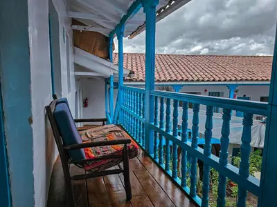a chair sitting on a balcony with a view at Hospedaje Euro's De San Blas in Cusco