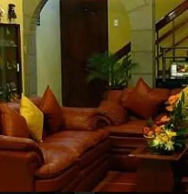 a brown leather couch in a living room at Hotel Inkayra in Cusco