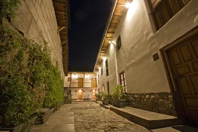 an alley in an old building at night at Tierra Viva Cusco Centro in Cusco