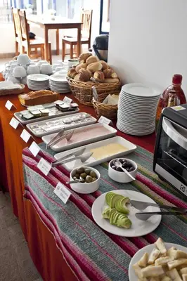 a table with plates of food on a table at Tierra Viva Cusco Centro in Cusco
