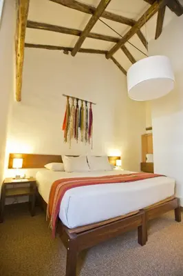 a bedroom with a large bed in a room at Tierra Viva Cusco Centro in Cusco