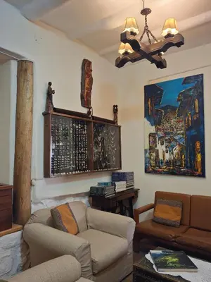 a living room with a couch and a chandelier at Casona La Recoleta in Cusco