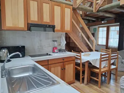a kitchen with a sink and a table in a room at Casona La Recoleta in Cusco