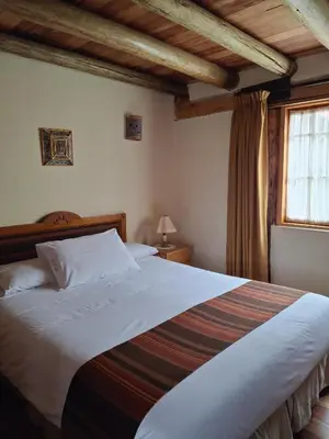a bedroom with a large bed and a window at Casona La Recoleta in Cusco
