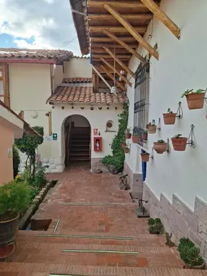 an alleyway leading to a house with a wooden roof at Casona La Recoleta in Cusco