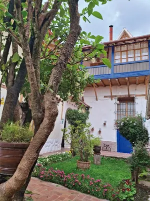 a house with a tree and flowers in the yard at Casona La Recoleta in Cusco