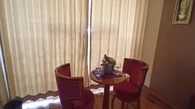 a small table with two chairs and a cup on it at Hs Tierra In in Machu Picchu