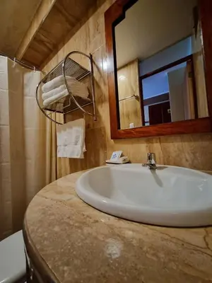 a bathroom with a sink and a mirror at Hs Tierra In in Machu Picchu