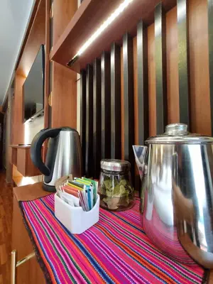 a table with a tea pot on top of a table at Hs Tierra In in Machu Picchu