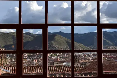 a view of a city through a window at Kuska Hostal in Cusco