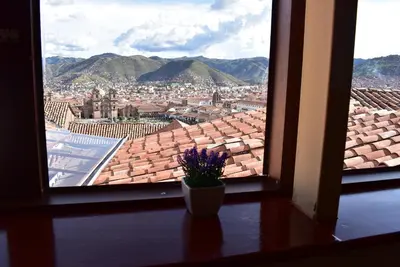 a view of a city from a window at Kuska Hostal in Cusco