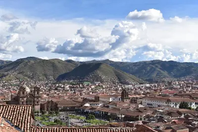 a view of a city with mountains in the background at Kuska Hostal in Cusco