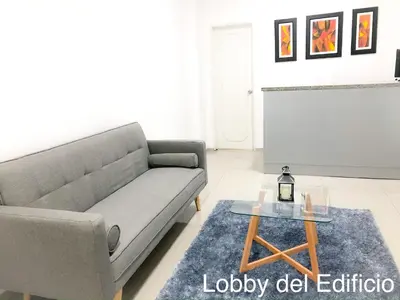 a living room with a couch and a table at Departamento Miraflores in Lima