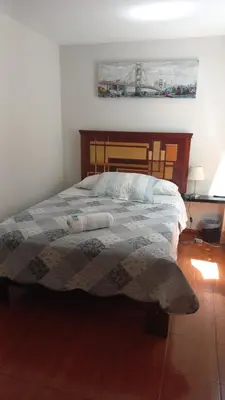 a bedroom with a bed with a quilt on it at CASA LOPEZ in Lima