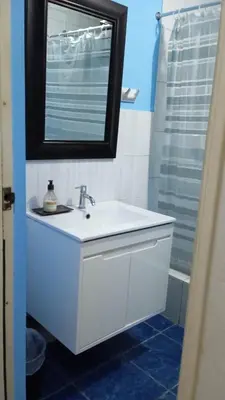 a bathroom with a white sink and a mirror at CASA LOPEZ in Lima