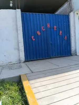 a blue gate with some signs on it at Hospedaje Anny in Larán