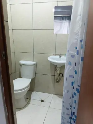 a bathroom with a toilet and a sink at Hospedaje Anny in Larán