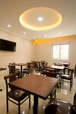 a dining room with tables and chairs and a ceiling at Martinika in Lima