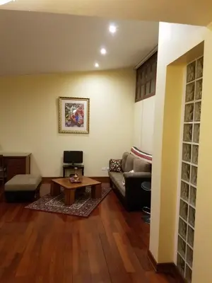a living room with a couch and a table at Entire Studio-Penthouse De Luxe in Lima