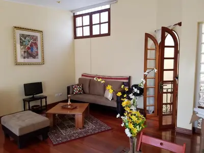 a living room with a couch and a table at Entire Studio-Penthouse De Luxe in Lima
