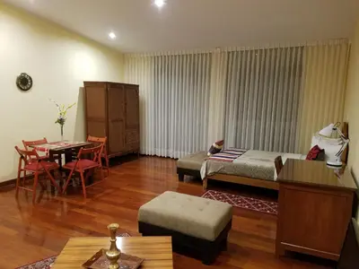 a living room with a bed and a table and chairs at Entire Studio-Penthouse De Luxe in Lima