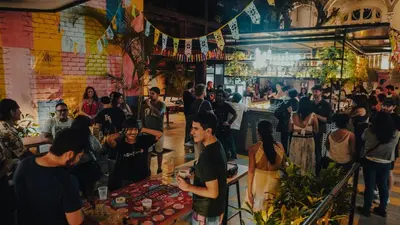 a crowd of people standing in a bar at Viajero Lima - Barranco Hostel in Lima