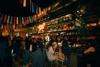 a group of people sitting at a bar at Viajero Lima - Barranco Hostel in Lima