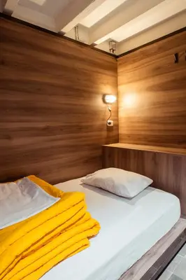 a bedroom with a bed with a wooden wall at Viajero Lima - Barranco Hostel in Lima