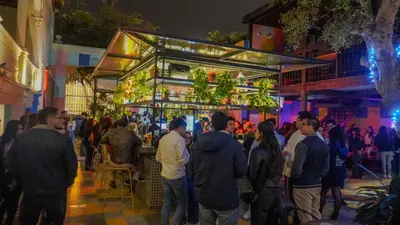 a crowd of people standing outside of a bar at Viajero Lima - Barranco Hostel in Lima