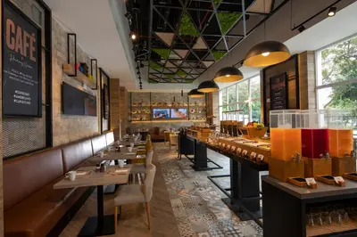 a restaurant with a row of tables and chairs at Casa Andina Premium San Isidro in Lima