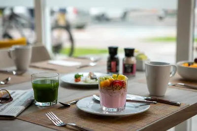 a table with a drink and plates of food on it at Casa Andina Premium San Isidro in Lima