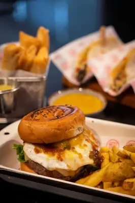 a plate of food with an egg sandwich and french fries at Casa Andina Premium San Isidro in Lima