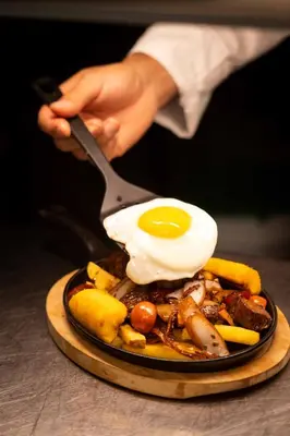 a plate of food with an egg on top at Casa Andina Premium San Isidro in Lima