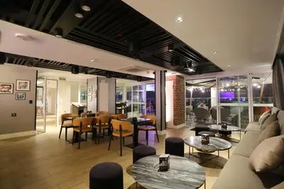 a lobby with tables and chairs and a restaurant at Casa Andina Premium San Isidro in Lima